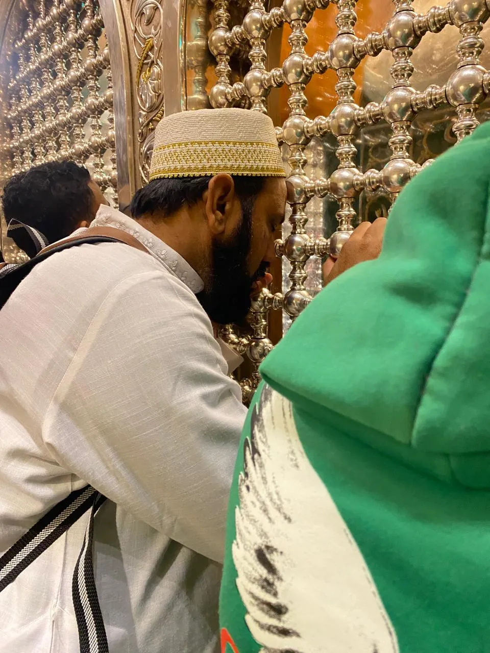 Man praying close to zarih